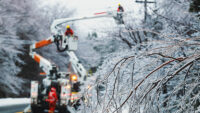 workers servicing an electrical utility line in the winter