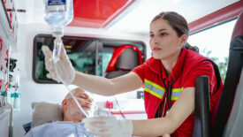 EMT loading a patient into an ambulance